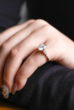 a woman's hand with a diamond ring on it