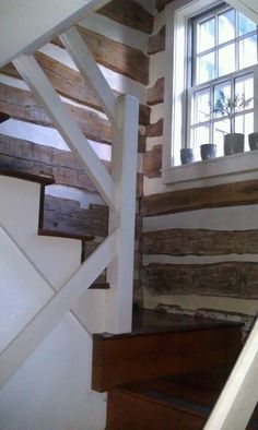 the stairs are made of wood and have white railings