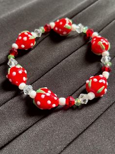 New to our jewel box is this cute and sweet strawberry glass bead bracelet. If you love fruits this is the perfect bracelet to add to your arm candy. Details -Bracelet Material: Glass -Bracelet Opening: Stretch Elastic Casual Glass Bracelets As Gift, Adjustable Beaded Bracelets With Fruit Design As Gift, Adjustable Beaded Bracelet With Fruit Design As Gift, Cute Red Beaded Bracelets With Heart Beads, Cute Red Beaded Bracelet With Heart Beads, Cute Red Bracelets With Colorful Beads, Cute Red Stretch Bracelet As Gift, Cute Red Stretch Bracelet Gift, Cute Red Beaded Bracelet