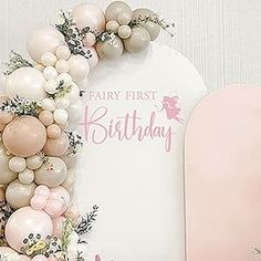 a baby's first birthday decoration with balloons and flowers