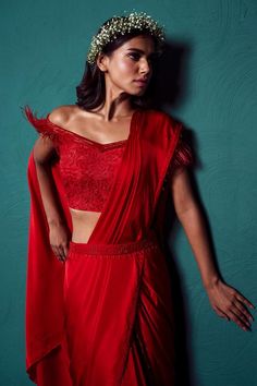 Red pre-draped plain saree in satin silk base with dangling beads on hem. Paired with off shoulder padded blouse with all over french knots bloom embroidery, feather detailing on the sleeves and embroidered belt.
Components: 3
Pattern: Embroidery
Type Of Work: French Knots
Neckline: Straight Neck
Sleeve Type: Off Shoulder
Fabric: Satin Silk
Color: Red
Other Details: 
Padded blouse
Length:
Saree: 43inches
Blouse: 15inches
Note: The gypsie tiara worn by the model is not for sale
Occasion: Sangeet, Red Traditional Drape Blouse For Evening, Plain Saree, Embroidered Belt, Drape Saree, French Knots, Red Satin, Silk Embroidery, Blouse Length, Saree Blouse