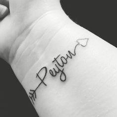 a person with a tattoo on their arm that reads, pattay and an arrow