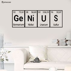 the chemical symbol for genius and genius wall decal in a living room with white furniture