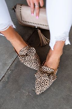 These pointed-toe faux suede leopard slides are real outfit makers. You really don't need much else to dress up your favorite pair of jeans! Almond toe Faux suede leopard print Bow accent Approx: 1.5" heel