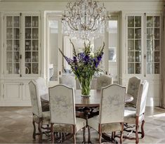 a dining room table with chairs and a chandelier