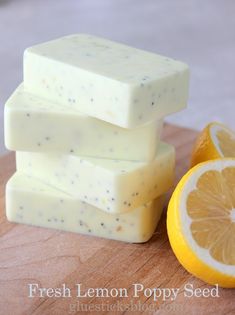 lemon and poppy seed soap bars on a cutting board next to an orange slice, with text overlay that reads fresh lemon poppy seed soap bar