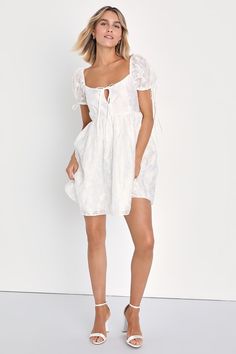 If sweetness is your middle name, you'll find your perfect match in the Lulus Exceptionally Angelic White Floral Puff Sleeve Mini Dress! Airy woven fabric, with a subtle sheen and darling floral appliques throughout, shapes this adorable dress. Short puff sleeves (with elastic at the shoulders and drawstring cuffs) frame a bodice with a cutout detail and a tie accenting the scoop neckline. Babydoll-style silhouette continues down to a mini hem. Hidden zipper/clasp at back. Fit: This garment fits Chic Summer Puff Sleeve Dress With Bubble Hem, Elegant Summer Mini Dress With Bubble Hem, Elegant Bubble Hem Mini Dress For Summer, Fitted Puff Sleeve Dress With Bubble Hem, Summer Ruched Puff Sleeve Dress With Bubble Hem, Spring Brunch Puff Sleeve Dress With Bubble Hem, Summer Puff Sleeve Dress With Ruched Bubble Hem, Feminine Mini Dress With Bubble Hem, Chic Mini Dress With Bubble Hem For Brunch