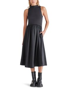 An elevated take on the bestselling Berlin dress. Add some elevated style to your wardrobe with the Aradia Mixed Media Dress. With a fitted stretchy bodice and flare bottom, this dress offers a flattering fit. The side pockets add functionality, while the dress can easily be dressed up with gold jewelry and a block heel or kept casual with lug boots and a jean jacket. Black mixed knit- super soft and stretchy top Funnel neck Hidden zip back closure Side pockets The material is 100% Polyester. Th Mixed Media Dress, Lug Boots, Elevated Style, Stretchy Tops, Sweater Tank Top, Satin Skirt, Versatile Dresses, Dress Trousers, Funnel Neck