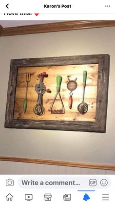 a wooden framed artwork with kitchen utensils on it