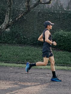 a man running in the street with a hat on