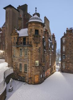 an old building with snow on the ground