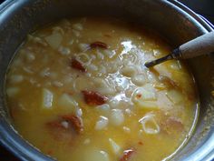 a bowl filled with pasta and meat soup