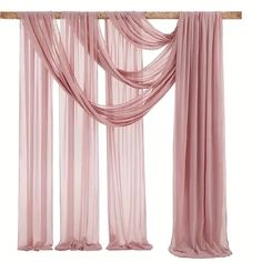 pink sheer curtains hanging on a wooden rod