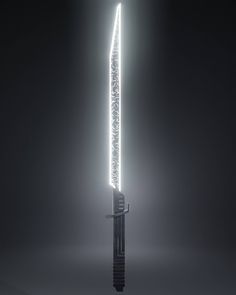 a tall metal object with lights on it's side in the middle of a dark room