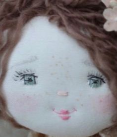 a close up of a doll with brown hair and flowers on it's head