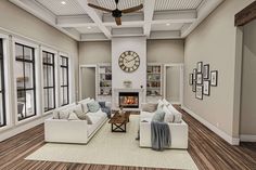 a living room filled with furniture and a fire place in the middle of a room