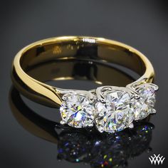 three stone diamond ring on black background