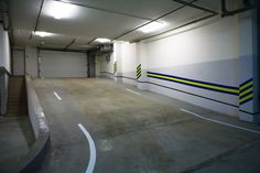 an empty parking garage with yellow and blue stripes