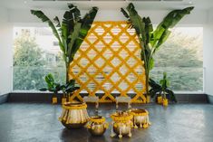 a room with yellow decorations and plants in it