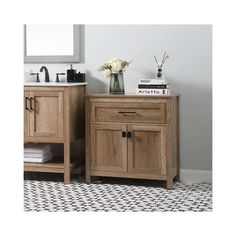 a bathroom vanity with two drawers and a mirror above it, next to a tiled floor