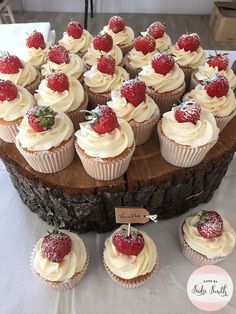 cupcakes with white frosting and strawberries on top