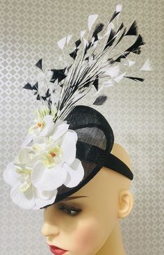 Stunning black and ivory teardrop fascinator  with ivory  orchid, flowers  and  coque  feathers  plus  embellishments. Great for your celebration event. Black Wedding Fascinator For Spring, Black Headpiece For Spring Wedding, Black Feathered Wedding Costume Hat, Black Feathered Costume Hat For Wedding, Black Feathered Fascinator For Spring, Black Feather Headpiece For Spring, Elegant Black Fascinator With Handmade Flowers, White Feathered Fascinator For Formal Occasions, White Feather Fascinator For Formal Events