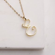 E Initial Necklace - Cursive "E" initial gold pendant - Personalized initial gold pendant for women / Gift for her / for mom / for wife / Cursive "E" initial. Perfect every day necklace. Lovely gift for your self, sister, bridesmaids, new mom. Pendant: Base metal is brass and 14K gold plated. Chain is 18 inches, 14k gold filled. Note: model shots might show a different initial, only to illustrate overall look and length of the chain. This listing is for the "E" initial. E Necklace Initial, Cursive E, E Initial Necklace, Friend Letters, Every Day Necklace, E Initial, Souvenir Jewelry, Sideways Initial Necklace, Dainty Pendant