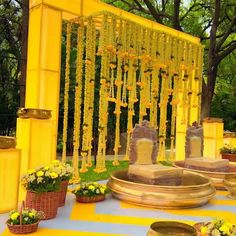 an outdoor ceremony with yellow flowers and decorations