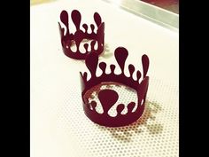 two red crowns sitting on top of a table