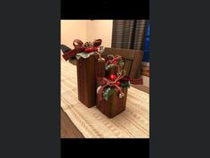 two christmas present boxes sitting on top of a table