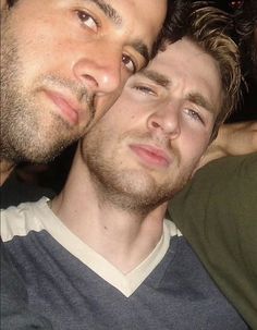 two men are posing for the camera with one man's face close to him