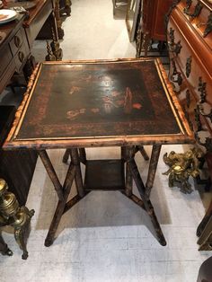 an old table is surrounded by other antique furniture