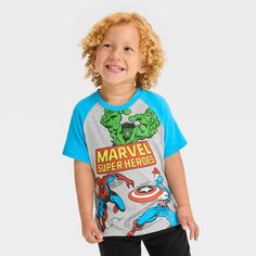 Prep your little tyke to join forces with the mightiest superheroes in this Marvel Graphic T-Shirt. Tailored in a regular fit and featuring a tagless design, this short-sleeve T-shirt is crafted from lightweight fabric for all-day cool comfort. Featuring blue raglan sleeves, this crewneck tee features comic-style graphics of the Hulk, Captain America and Spider-Man on a gray background to excite your little Avenger. Blue Superhero T-shirt With Character Print, Superhero Short Sleeve T-shirt With Character Print, Superhero Cartoon Print Cotton T-shirt, Green Themed T-shirt With Short Sleeve, Themed Green Short Sleeve T-shirt, Green Themed Short Sleeve T-shirt, Blue Superhero Short Sleeve Top, Superhero Character Print Short Sleeve T-shirt, Playful Short Sleeve Top For Fan Merchandise