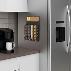 there is a coffee maker on the counter next to a refrigerator with magnets in it