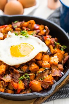 a skillet filled with hash browns and an egg