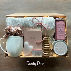 a gift box filled with personal care items, such as a mug and tea bag