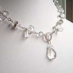 This wedding jewelry crystal quartz necklace created by Jewelry By CARMAL is made of: clear crystal quartz gemstones, clear rhinestone connectors, rhinestone spacers, sterling silver: connector, bead caps, spring clasp and findings. This necklace measures 18 inches in length. WE OFFER FREE STANDARD SHIPPING WITHIN THE UNITED STATES! All of our jewelry is unique and custom designed. Most of our jewelry can easily be resized. If there is a piece of jewelry that you are interested in, but would lik Faceted Crystal Necklaces For Wedding, Faceted Crystal Necklace For Wedding, Clear Crystal Necklace For Weddings, Clear Crystal Necklaces For Wedding, Elegant Clear Crystals For Jewelry Making, Wedding Jewelry Crystal, Crystal Quartz Necklace, Jewelry Bride, Crystal Wedding Jewelry