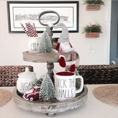 two mugs are stacked on top of each other in front of a christmas tree