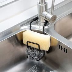 a sponge is being used to clean a stainless steel sink