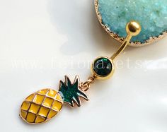 a yellow and green pineapple belly button navel bar with gold plated accents