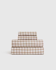 three sheets with brown and white checkered pattern on the bottom, one is folded in half