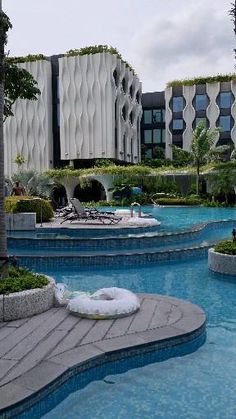 an empty swimming pool in the middle of a resort