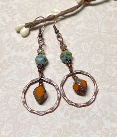 Casual boho earrings with a rustic fall vibe.  These were created using orange Czech Picasso glass bi-cone beads, turquoise Czech Picasso English cut beads, small Czech beads in champagne, antique copper accents, and antique copper hammered hoops. These earrings are great for fall, but the boho vibes are also great any time of year! Total length of earrings, including the ear wire, is approximately 2-1/2".  The hoops measure slightly less than 1" x 1". For matching bracelet, click on the link below: https://www.etsy.com/listing/1804981873/rustic-boho-bracelet-great-for-fall?click_key=abd72bb77c96c982d63f30c522f196ec4baca950%3A1804981873&click_sum=dfe57588&ref=shop_home_active_1&frs=1&sts=1 Thank you for shopping with The Lucie Collection! Bohemian Nickel-free Rust Earrings, Bohemian Rust-colored Nickel-free Earrings, Bohemian Rust Earrings With Ear Wire, Rust Bohemian Earrings For Pierced Ears, Rustic Drop Earrings With Ear Wire, Bohemian Copper Hoop Earrings, Bohemian Teardrop Copper Hoop Earrings, Rustic Dangle Earrings For Festivals, Bohemian Brown Wire Wrapped Hoop Earrings