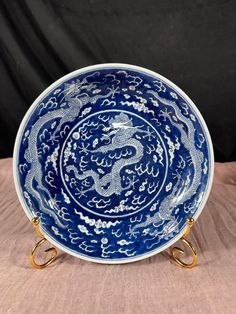 a blue and white dragon plate with gold handles