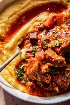 a bowl filled with meat and mashed potatoes