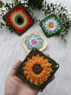 crocheted coasters with flowers and leaves in them on a white furnishing