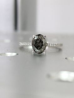 a diamond ring sitting on top of a table