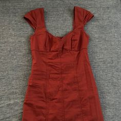 Women’s Burnt Red Mini Dress, Sweetheart Neckline, Small Cutout On Back With Elastic Strap Across Cutout, Body Fits Right To Sides, Cupped Shoulders, Side Zipper, Never Worn! Perfect Condition, Extremely Cute And Feminine, Can Be Dresses Up Or Down! Size Small Urban Outfitters Fitted V-neck Mini Dress, Fitted V-neck Mini Dress By Urban Outfitters, Red Lined Cotton Mini Dress, Red Casual Mini Dress With Sweetheart Neckline, Cotton Mini Dress With Sweetheart Neckline For Date Night, Fitted Cotton Dress By Urban Outfitters, Urban Outfitters Fitted Cotton Dress, Red Mini Length Dresses By Urban Outfitters, Urban Outfitters Short Sleeve Mini Dress For Date Night