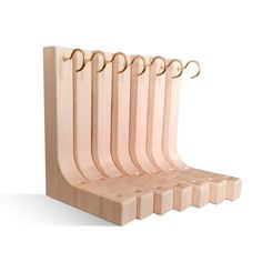 a set of five wooden cutting boards with hooks on each one side and the other end