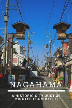 a street with lots of telephone poles and buildings on both sides that read, nagahama a historic city just 30 minutes from tokyo